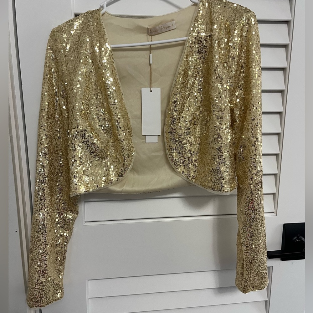 A gold sequin jacket. Never been worn! Brand new!